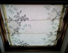 a window with a flowered valance hanging from it's side