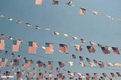 many american flags are hanging from a line