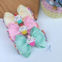 three small bows with cupcakes on them