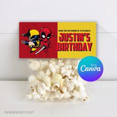 a bag of popcorn sitting on top of a table next to a tag that says, justin's birthday