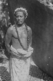 an old black and white photo of a man in native clothing