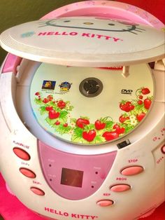 the hello kitty cd player has been decorated with flowers and cherries on it's side