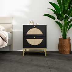 a black and gold cabinet next to a bed with a plant in it on the side