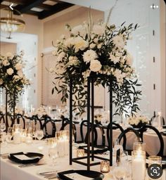 the centerpieces are decorated with white flowers and candles