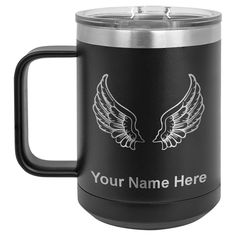 a stainless steel mug with the words your name here on it and two large white wings