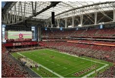 a stadium filled with lots of people watching a football game