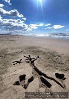 the sand is made to look like it has been carved in the shape of a cross