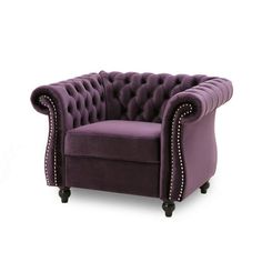 a purple velvet chair with studded trimmings on the arms and back, sitting in front of a white background