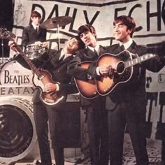 three men in suits and ties are playing guitars