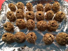 a bunch of cookies that are on some tin foil and ready to be baked in the oven