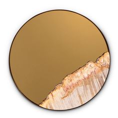 a round mirror with an abstract design in the middle and gold paint on it's surface