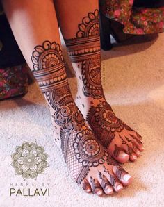 the legs and feet of a woman with henna tattoos