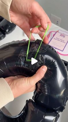 a person is holding an inflatable balloon and stringing it to the side