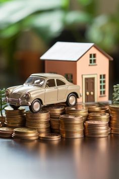 a toy car sitting on top of stacks of coins next to a house and tree