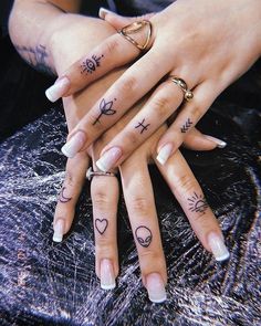 two people with tattoos on their hands and fingers