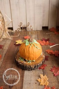 a pumpkin sitting on top of a wooden table