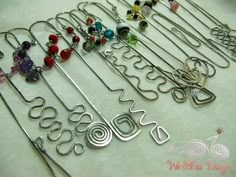 many different types of jewelry hangers on a table