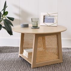 a small table with some books on it and a potted plant in the corner