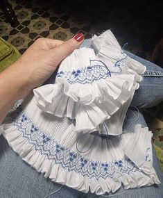 a woman's hand is on top of a piece of cloth that has been sewn