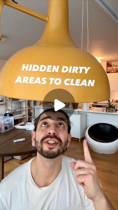 a man holding up a sign that says hidden dirty areas to clean in front of him