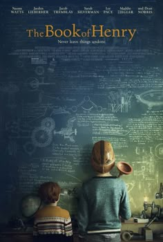 the book of henry movie poster with two children looking at an old fashioned typewriter