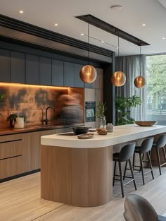 a modern kitchen with an island counter and bar stools