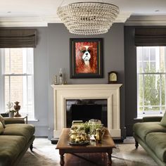 a living room with two couches and a coffee table in front of a fireplace