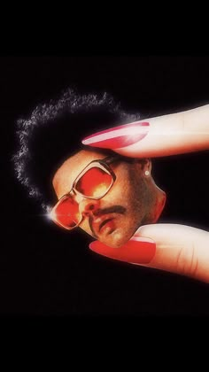 a person with red nails and sunglasses on their face is holding his hand up to the camera