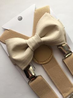 Adorable bow tie, made with 100% cotton. Size 6m-2yo: adjustable elastic  suspenders run from 16"- 25" long, bow tie's neck strap is about 14" long; (adjustable), velcro closureSize 3yo-5yo: adjustable elastic suspenders run from 16"-25" long, bow tie's neck strap is about 15" long; (adjustable), velcro closureSize 6yo-12yo: adjustable elastic suspenders run from 21"-34" long, bow tie's neck strap is about 16 1/2" long; (adjustable), velcro closureSize adult up to 5'6": adjustable elastic suspen Champagne Chambelan Suits, Brown Chambelan Suits, Champagne Dama Dresses, Gold Dama Dresses, Chambelanes Outfits Quinceanera, Chambelan Outfits, Red Quince Theme, Tan Bow Tie, Dama Dresses Quinceanera