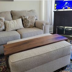 a living room with a couch, coffee table and television