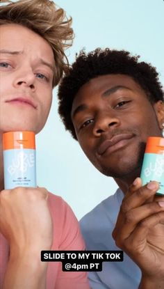 two men are holding up some kind of deodorant in front of their faces