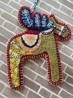 an elephant ornament hanging on a brick wall