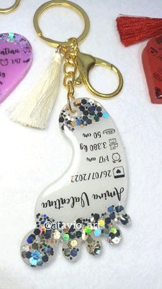 the key chain is decorated with swaroes and other things that are on display