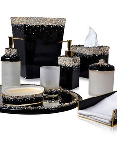 black and white bathroom accessories with gold accents