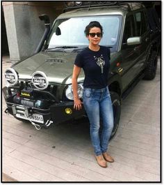 a woman standing in front of a car