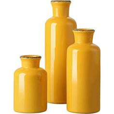 three yellow vases sitting next to each other