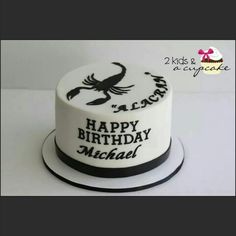 a white birthday cake with black lettering on it