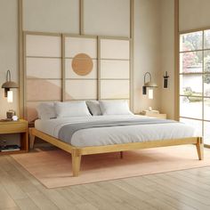 a large bed sitting on top of a hard wood floor next to a wooden table