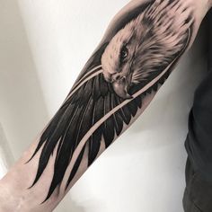 a man's arm with an eagle tattoo on it