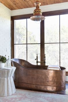 rustic modern bathroom with copper soaking tub Lauren Leiss, Cowboy Tub, Dream Bathtub, Handcrafted Dining Table, Paneled Ceiling, Space Bathroom, Copper Tub, Copper Light