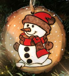 a wooden ornament with a snowman on it