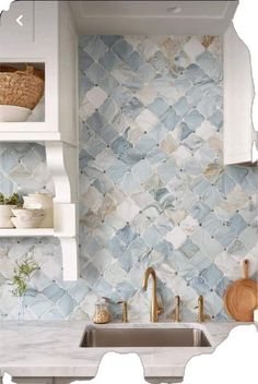 a kitchen with blue and white tiles on the wall, sink and shelving above it