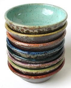 a stack of ceramic bowls sitting on top of each other