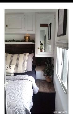 an rv bedroom makeover with white walls and wood flooring