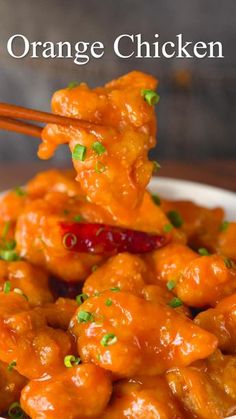 orange chicken with chopsticks in a white bowl on a wooden table and text overlay that says orange chicken