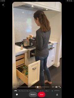 a woman standing in front of a stove top oven