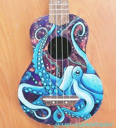 an octopus ukulele is painted with blue and purple colors