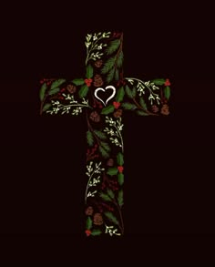 a cross decorated with holly, pine cones and a heart in the center on a black background