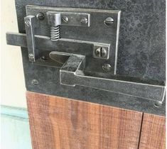 a close up of a metal latch on a wooden door