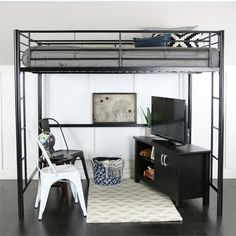 a loft bed with a desk underneath it and a tv on the top shelf next to it